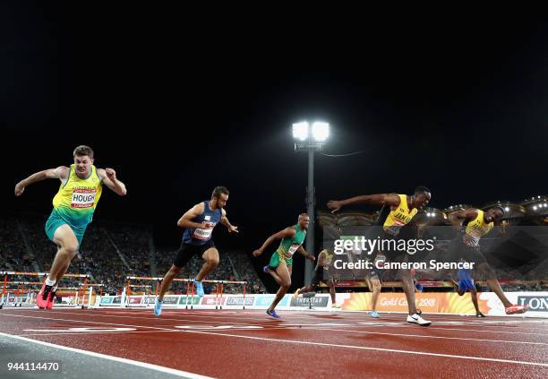 Ronald Levy of Jamaica crosses the line to win gold ahead of Hansle Parchment of Jamaica in the Men's 110 hurdles final during the Athletics on day...