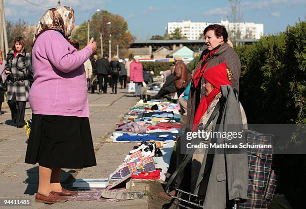 Old woman sell clothes October 19, 2008 at a fleemarket in Tiraspol in the Transnistria region in Moldova. Tiraspol is the second largest city in...
