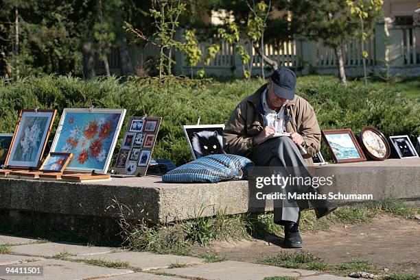 Man sells paintings on October 19, 2008 at a fleemarket in Tiraspol in the Transnistria region in Moldova. Tiraspol is the second largest city in...