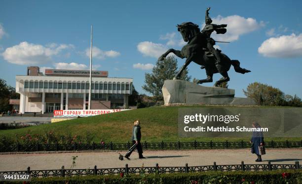 Woman pass October 19, 2008 the statue of Alexander Suvorov the founder of Tiraspol in the Transnistria region in Moldova. Tiraspol is the second...