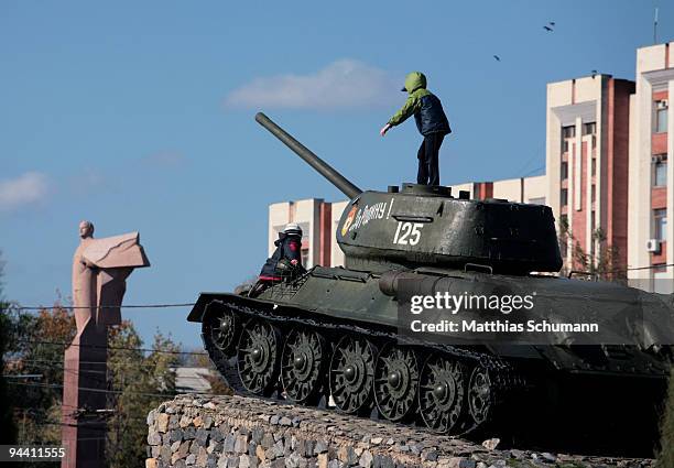 Two boys are climbing a Soviet T-34 tank, commemorating the Soviet victory in World War II on October 19, 2008 in front of the Transnistrian...