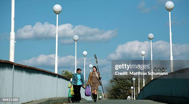 Woman cross a bridge over the river Dniestre on October 19, 2008 in Tiraspol, Moldova. Tiraspol is the second largest city in Moldova and is the...