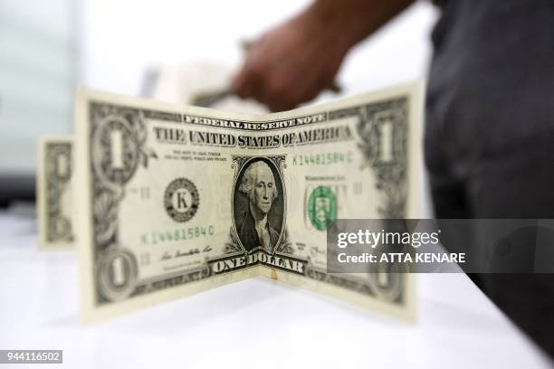 Close up shot shows a one US dollar bill placed on a table in Tehran on April 10, 2018. - Iran took the drastic step of fixing the rate of its...