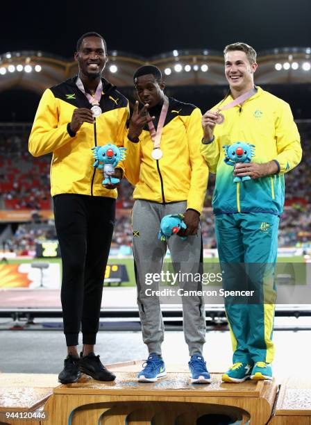 Silver medalist Hansle Parchment of Jamaica, gold medalist Ronald Levy of Jamaica and bronze medalist Nicholas Hough of Australia pose during the...