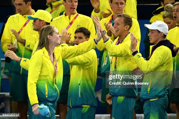 Gold medalist Emily Seebohm of Australia celebrates with her teammates following the medal ceremony for the Women's 50m Backstroke Final on day six...