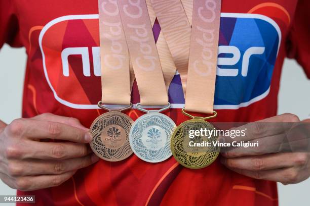 James Wilby of England poses with 50m Breaststroke Bronze, 100m Breaststroke Silver & 200m Breaststroke Gold at team England Headquarters in Main...
