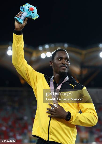 Silver medalist Hansle Parchment of Jamaica celebrates during the medal ceremony for the Mens 110 hurdles during the Athletics on day six of the...