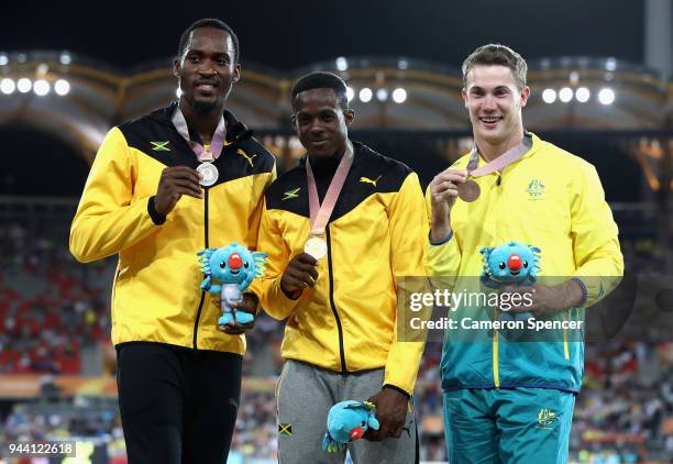 Silver medalist Hansle Parchment of Jamaica, gold medalist Ronald Levy of Jamaica and bronze medalist Nicholas Hough of Australia pose during the...
