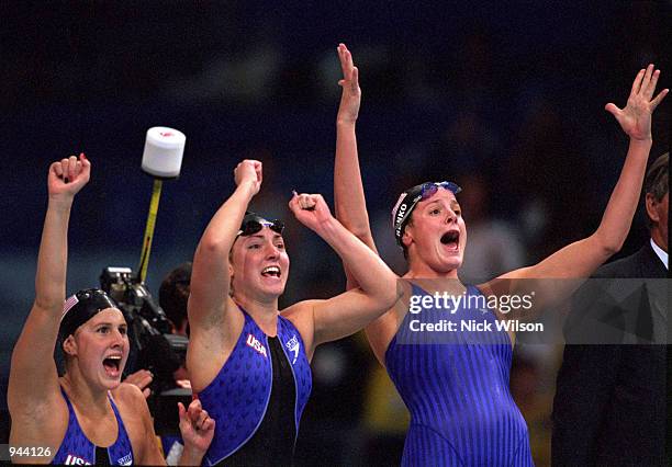 Samantha Arsenault, Diana Munz, Lindsay Benko of the USA cheer on anchor leg swimmer Jenny Thompson during their Gold Medal win in the Womens 4 x...