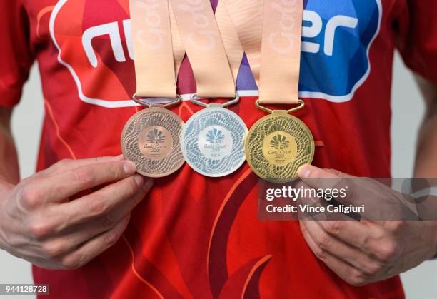 James Wilby of England poses with 50m Breaststroke Bronze, 100m Breaststroke Silver & 200m Breaststroke Gold at team England Headquarters in Main...