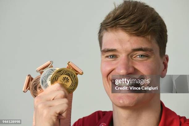 James Wilby of England poses with 50m Breaststroke Bronze, 100m Breaststroke Silver & 200m Breaststroke Gold at team England Headquarters in Main...