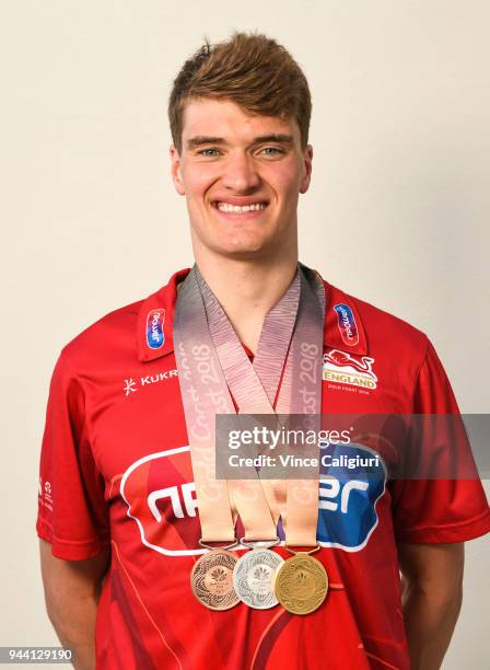 James Wilby of England poses with 50m Breaststroke Bronze, 100m Breaststroke Silver & 200m Breaststroke Gold at team England Headquarters in Main...