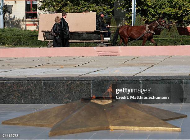 Man on a horse-drawn carriage pass the eternal flame dedicatet to those who fell defending Tiraspol in 1941 and liberating it in 1944 on October 19,...