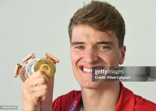 James Wilby of England poses with 50m Breaststroke Bronze, 100m Breaststroke Silver & 200m Breaststroke Gold at team England Headquarters in Main...