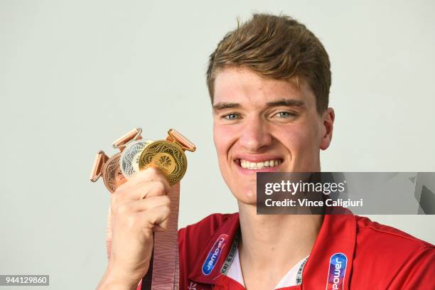 James Wilby of England poses with 50m Breaststroke Bronze, 100m Breaststroke Silver & 200m Breaststroke Gold at team England Headquarters in Main...