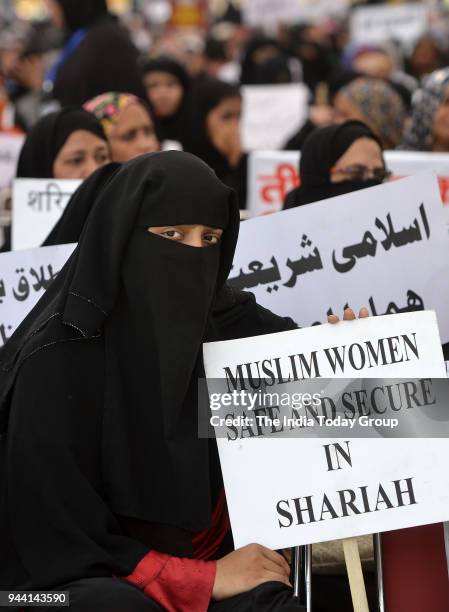 Muslim women display placards during a protest against 'Triple Talaq' bill in New Delhi.