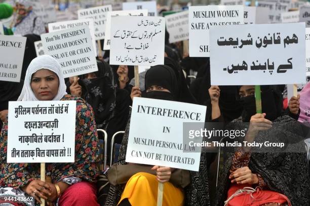 Muslim women display placards during a protest against 'Triple Talaq' bill in New Delhi.