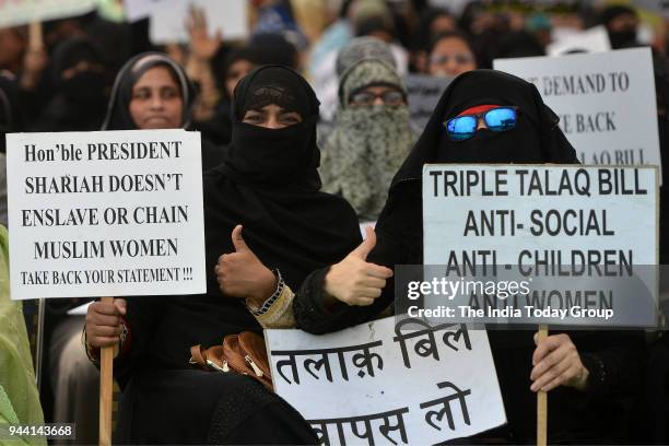 Muslim women display placards during a protest against 'Triple Talaq' bill in New Delhi.