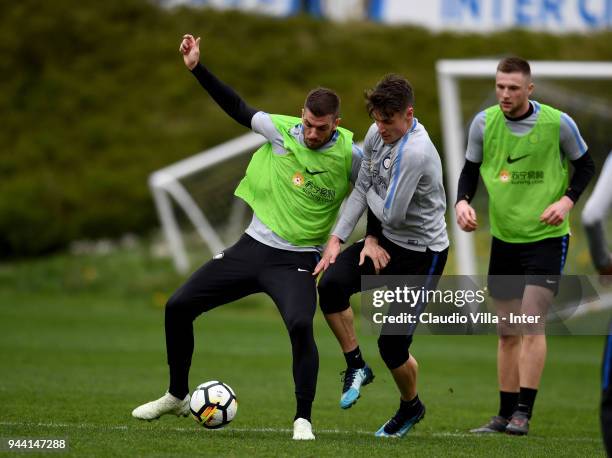 Davide Santon and Andrea Pinamonti of FC Internazionale compete for the ball during the FC Internazionale training session at the club's training...