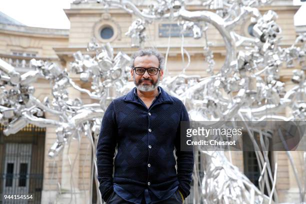 Indian contemporary artist Subodh Gupta poses in front of his artwork "People Tree" prior to the opening of his retrospective exhibition...
