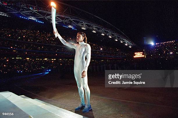Torchbearer Cathy Freeman of Australia prepares to light the Olympic Flame during the Opening Ceremony of the Sydney 2000 Olympic Games at the...