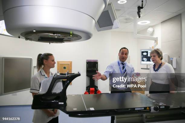 British Prime Minister Theresa May is shown the advanced radiotherapy system during a visit to announce new funding and research into prostate cancer...