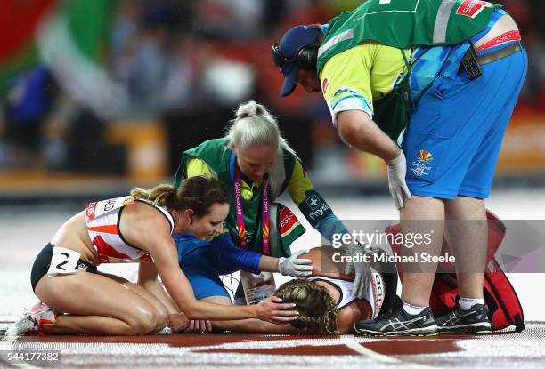 Jessica Judd of England is given assistance after the Women's 1500 metres final during the Athletics on day six of the Gold Coast 2018 Commonwealth...