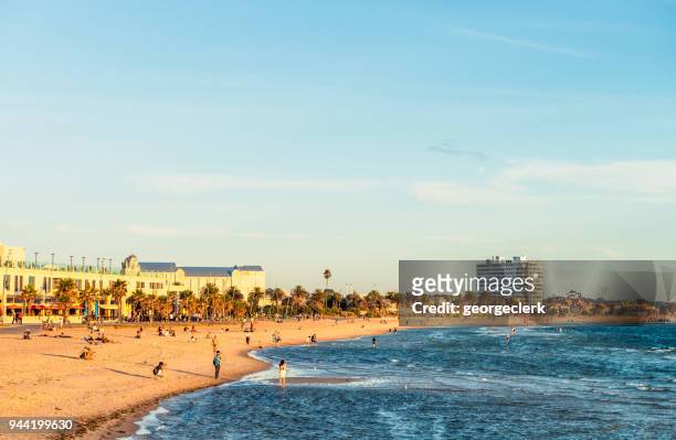 people on the beach at st kilda, melbourne - st kilda beach stock pictures, royalty-free photos & images