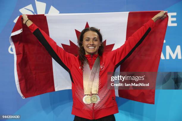 Kylie Masse of Canada poses with the four medals she won in the pool on day six of the Gold Coast 2018 Commonwealth Games at Optus Aquatic Centre on...