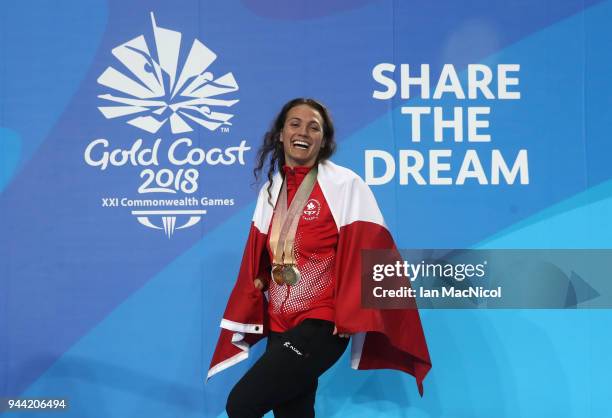 Kylie Masse of Canada poses with the four medals she won in the pool on day six of the Gold Coast 2018 Commonwealth Games at Optus Aquatic Centre on...