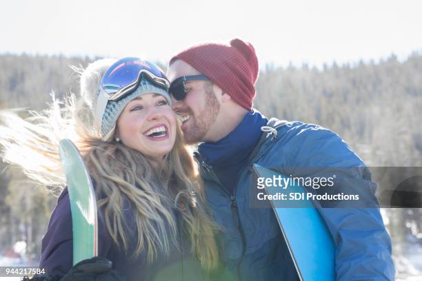 cheerful couple having fun on the ski slopes - ski jacket stock pictures, royalty-free photos & images