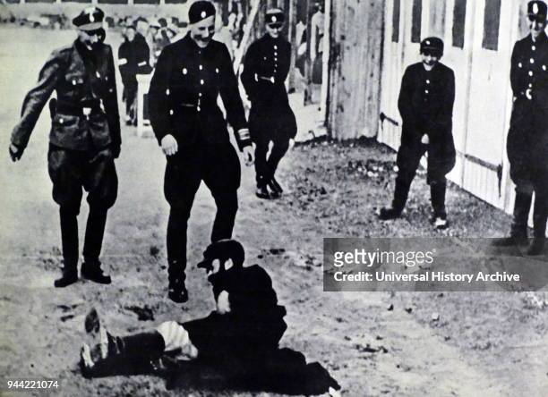 Nazi Police and soldiers attack a Jewish man in Gdansk, Poland after the German occupation of 1939.