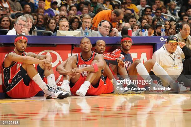 Courtney Lee, Bobby Simmons, Rafer Alston, and Sean Williams of the New Jersey Nets rest on the sidelines during the game against the Los Angeles...