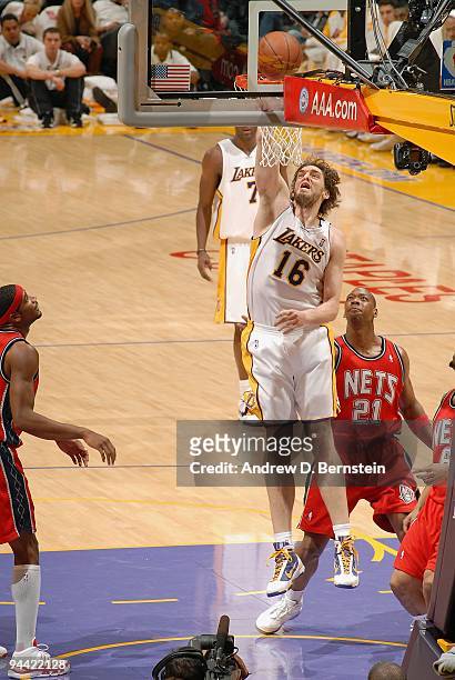 Pau Gasol of the Los Angeles Lakers lays up a shot against Bobby Simmons of the New Jersey Nets during the game on November 29, 2009 at Staples...
