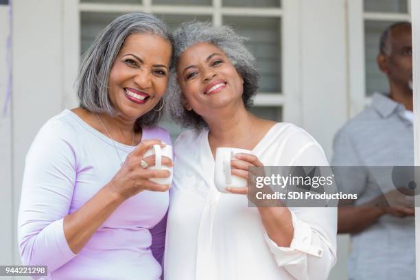 sisters enjoying coffee togehter - older sister stock pictures, royalty-free photos & images