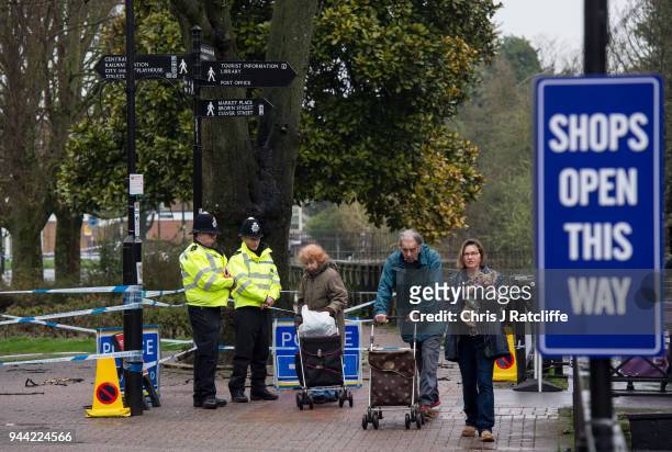 Police officers stand at a cordon near the scene where former double-agent Sergei Skripal and his daughter, Yulia were discovered after being...