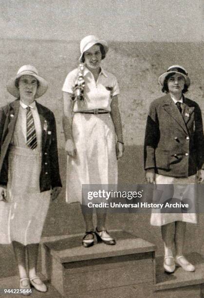 Photograph of the podium for the women's foil at the 1932 Olympic games. Ellen Muller-Preis took gold for Austria, Heather Seymour 'Judy' Guinness...