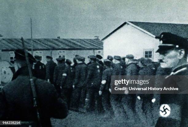 Prisoners enter Dachau concentration camp in 1933. Dachau was the first of the Nazi concentration camps opened in Germany, intended to hold political...