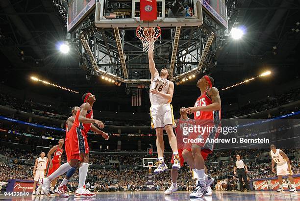 Pau Gasol of the Los Angeles Lakers lays up a shot against Bobby Simmons and Terrence Williams of the New Jersey Nets during the game on November 29,...