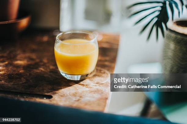 single glass of fresh orange juice - orange juice stock pictures, royalty-free photos & images