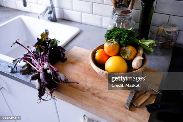 high angle view of fruits and vegetables on kitchen counter - caqui fruta tropical - fotografias e filmes do acervo