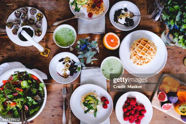 directly above shot of various food on wooden table - brunch stock-fotos und bilder