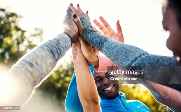 team for the win - black man high 5 stock pictures, royalty-free photos & images