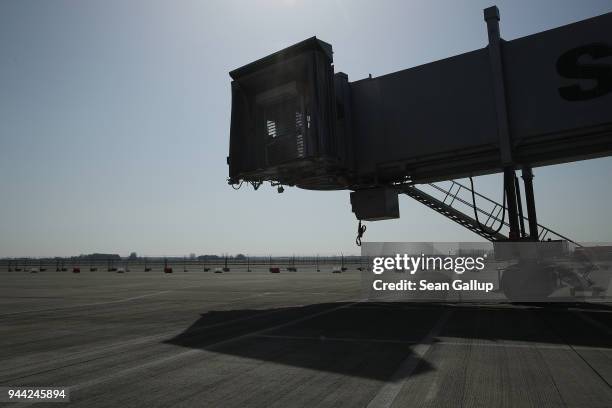 Passenger ramp stands leaning over the tarmac at the BER Willy Brandt Berlin Brandenburg International Airport on April 10, 2018 in Schoenefeld,...