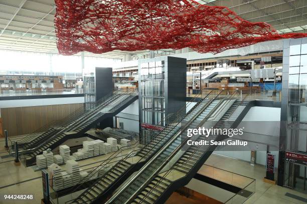 Stairs and escalators lead up to the main departures hall at the BER Willy Brandt Berlin Brandenburg International Airport on April 10, 2018 in...