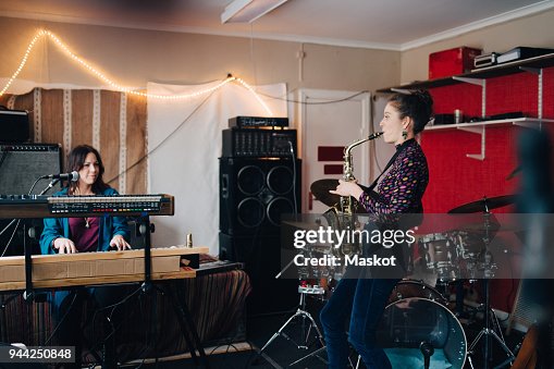 Performers playing instruments while practicing in studio Performers playing instruments while practicing in studio