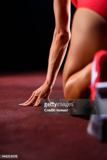close up of a female sprinter in a starting block - track starting block stock pictures, royalty-free photos & images