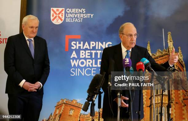 Former US special envoy George Mitchell looks on as former Irish Premier Bertie Ahern answers a question during a session with journalists at a...