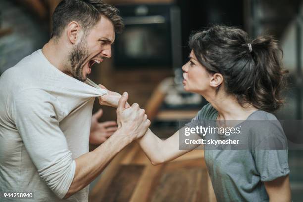 aggressive couple arguing about their problems at home. - rage stock pictures, royalty-free photos & images