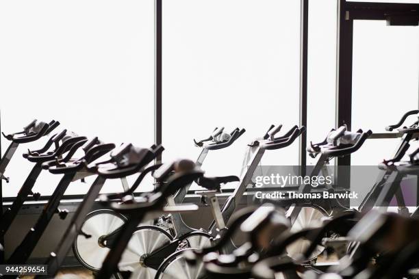 exercise bikes in fitness studio - exercise bike fotografías e imágenes de stock